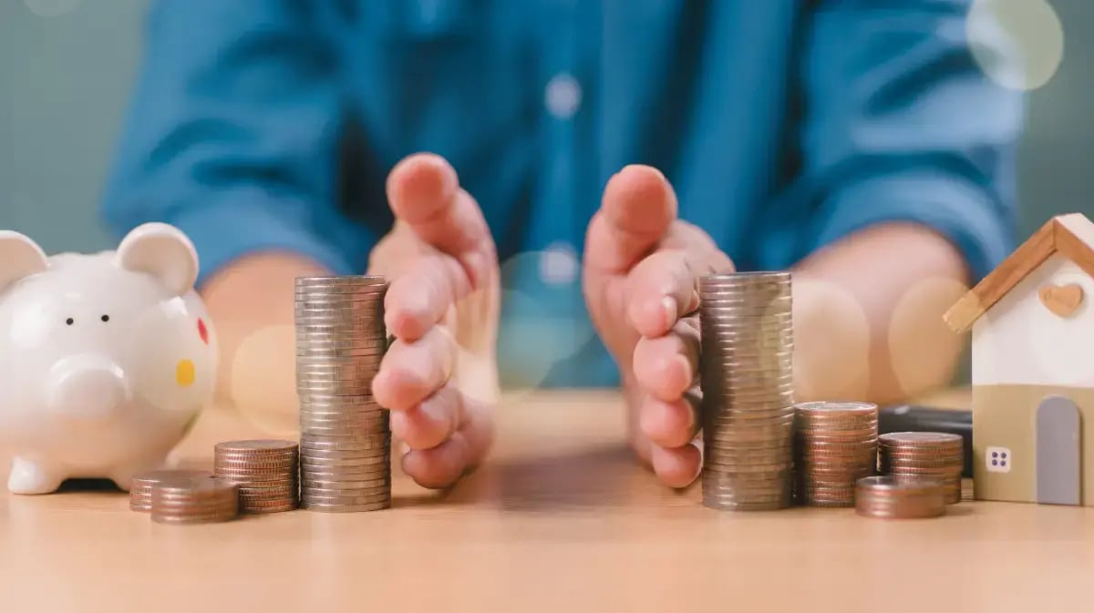 Hands separating two piles of money