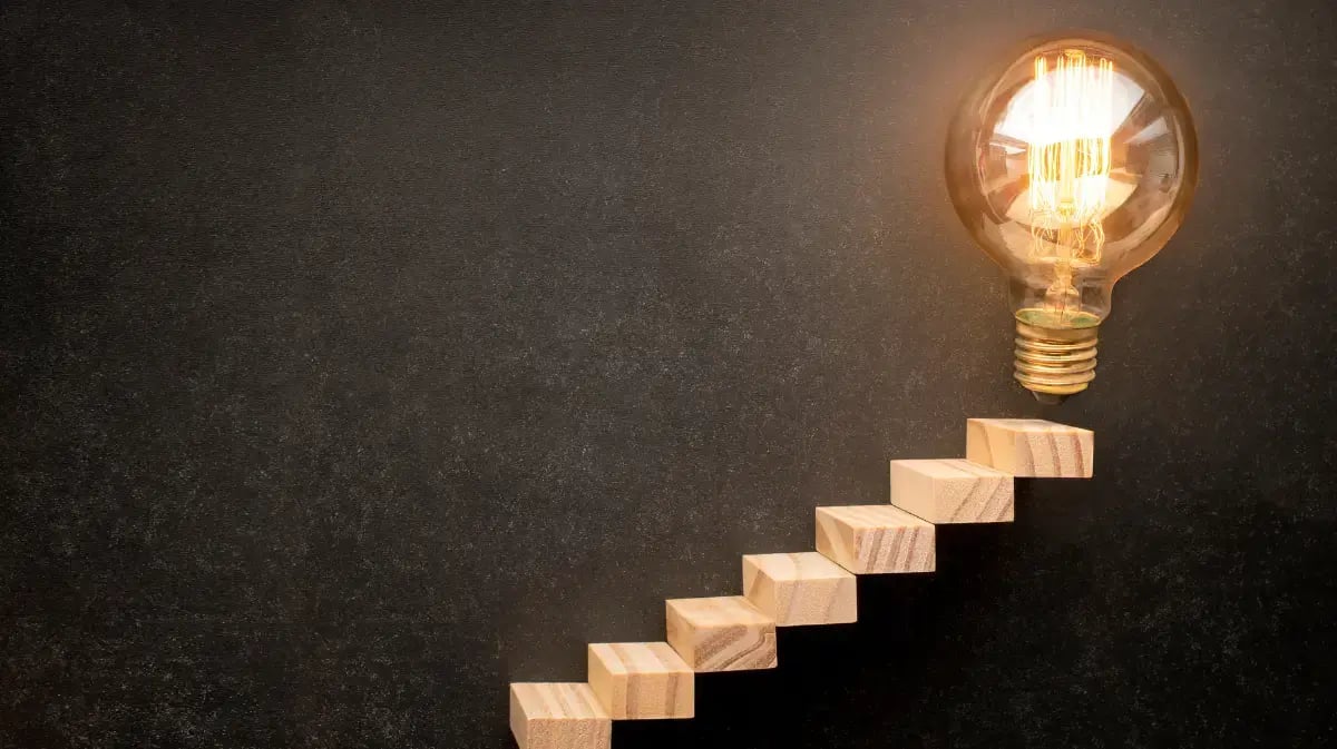 Steps that lead to an illuminated lightbulb